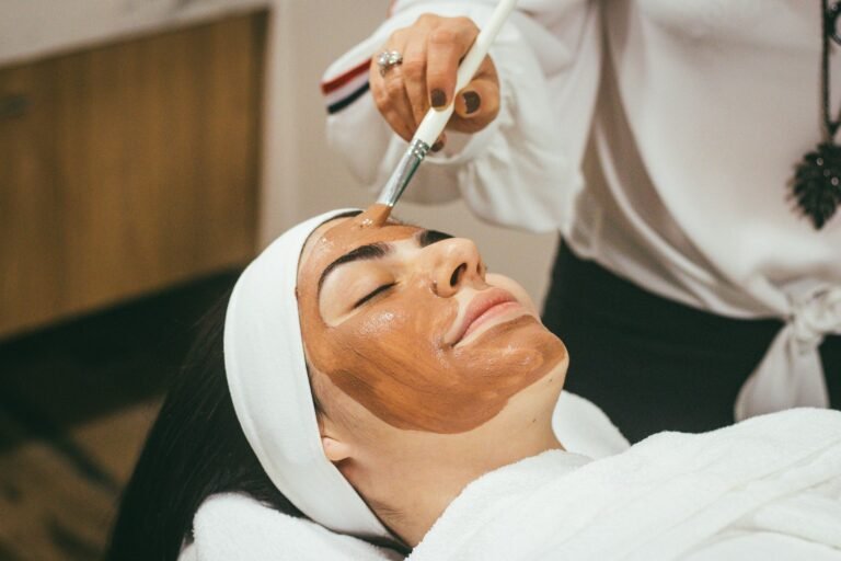 Practitioner reviewing skin notes with a client in a calm treatment room